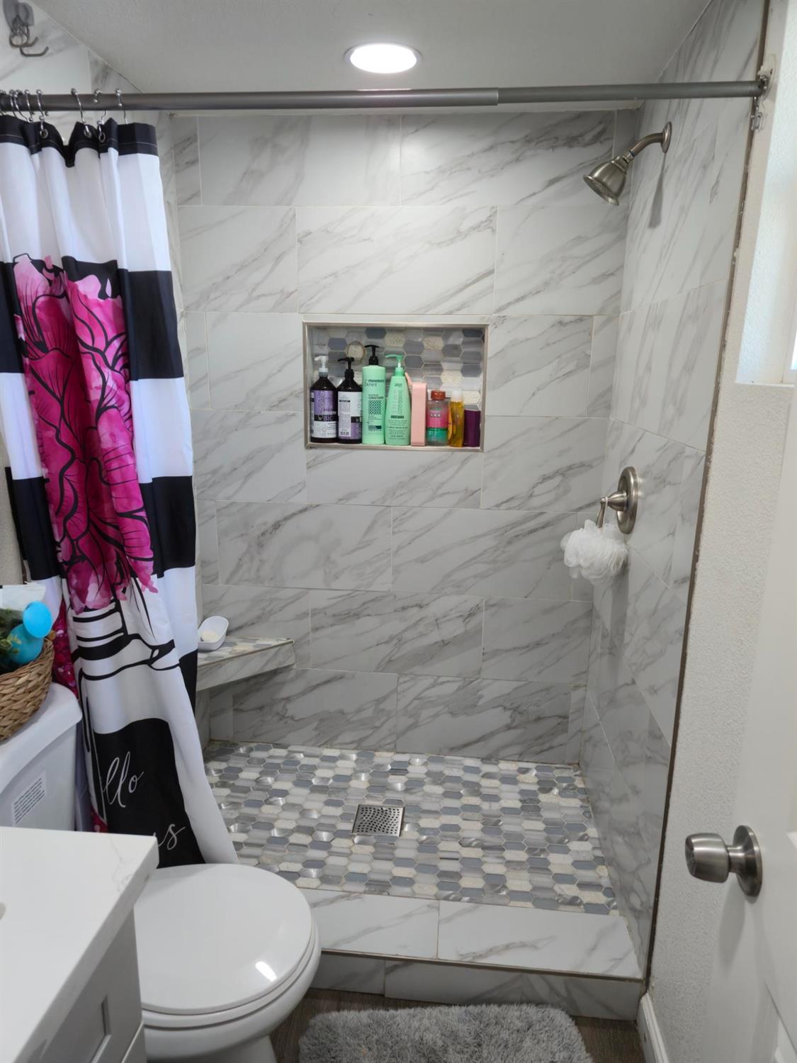 1284 Elizabeth Street, Unit 80 Coalinga, CA 93210 - Photo 18 of 24 a bathroom with a toilet and a shower