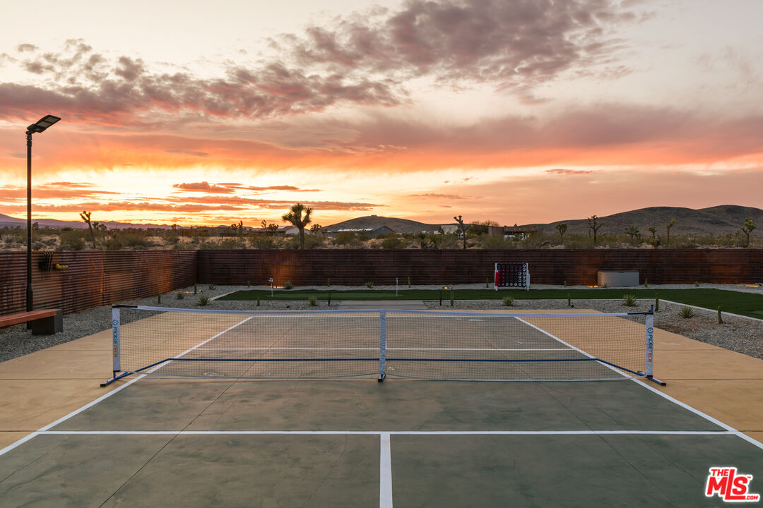 3000 Rockwood Road Joshua Tree, CA 92252 - Photo 34 of 71 a view of a tennis court with lots of buildings in the background