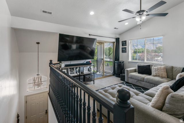 2515 West 450 South, Unit 2 Springville, UT 84663 - Photo 4 of 21 Vaulted ceilings, contemporary ceiling fan, sliding glass door with balcony, large window, and dark wood-finish railing