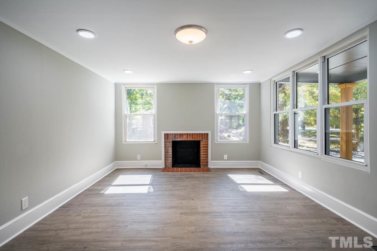 305 School House Road Efland, NC 27243 - Photo 21 of 35 an empty room with windows and fireplace