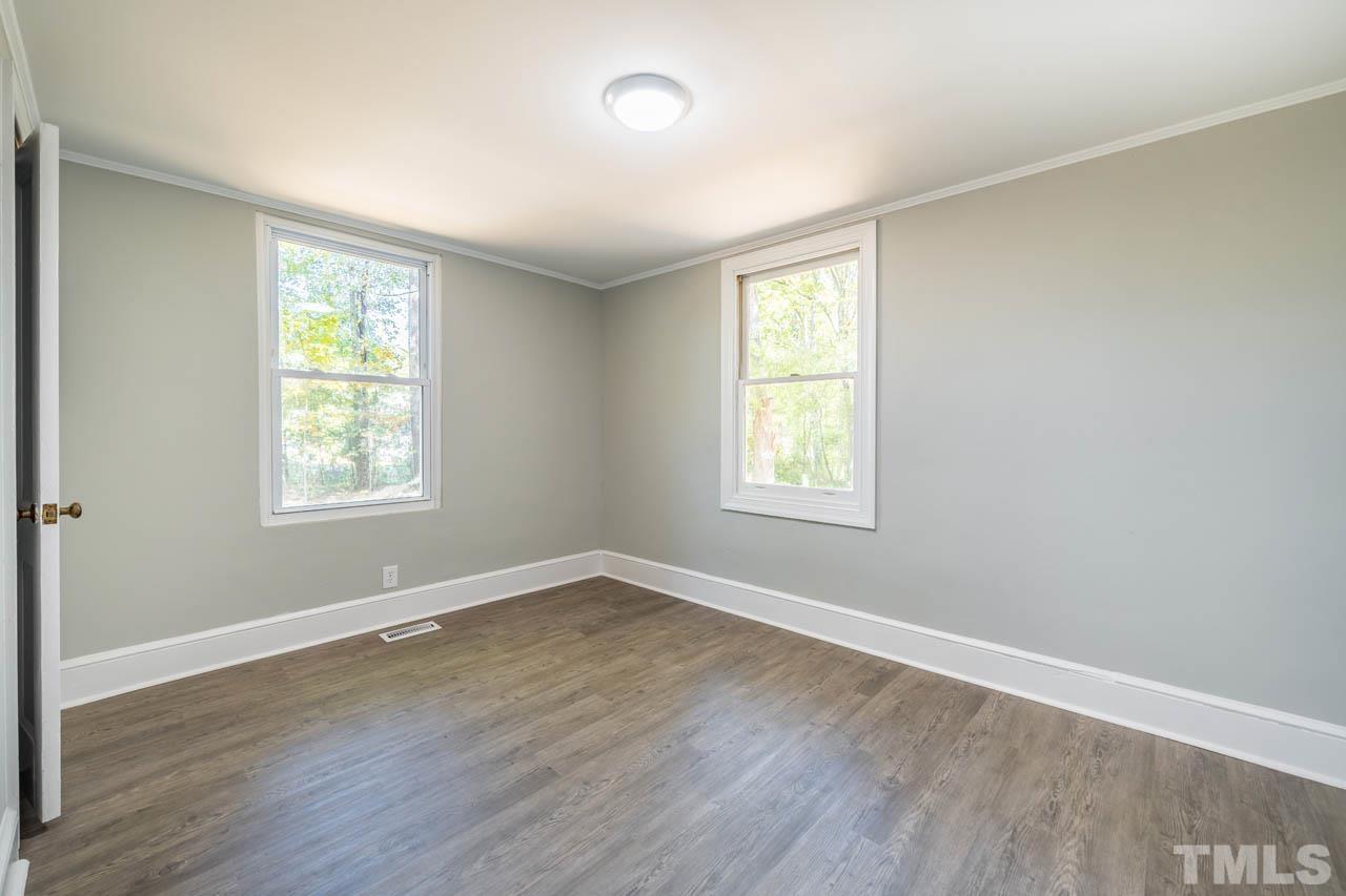 305 School House Road Efland, NC 27243 - Photo 27 of 35 an empty room with wooden floor and windows