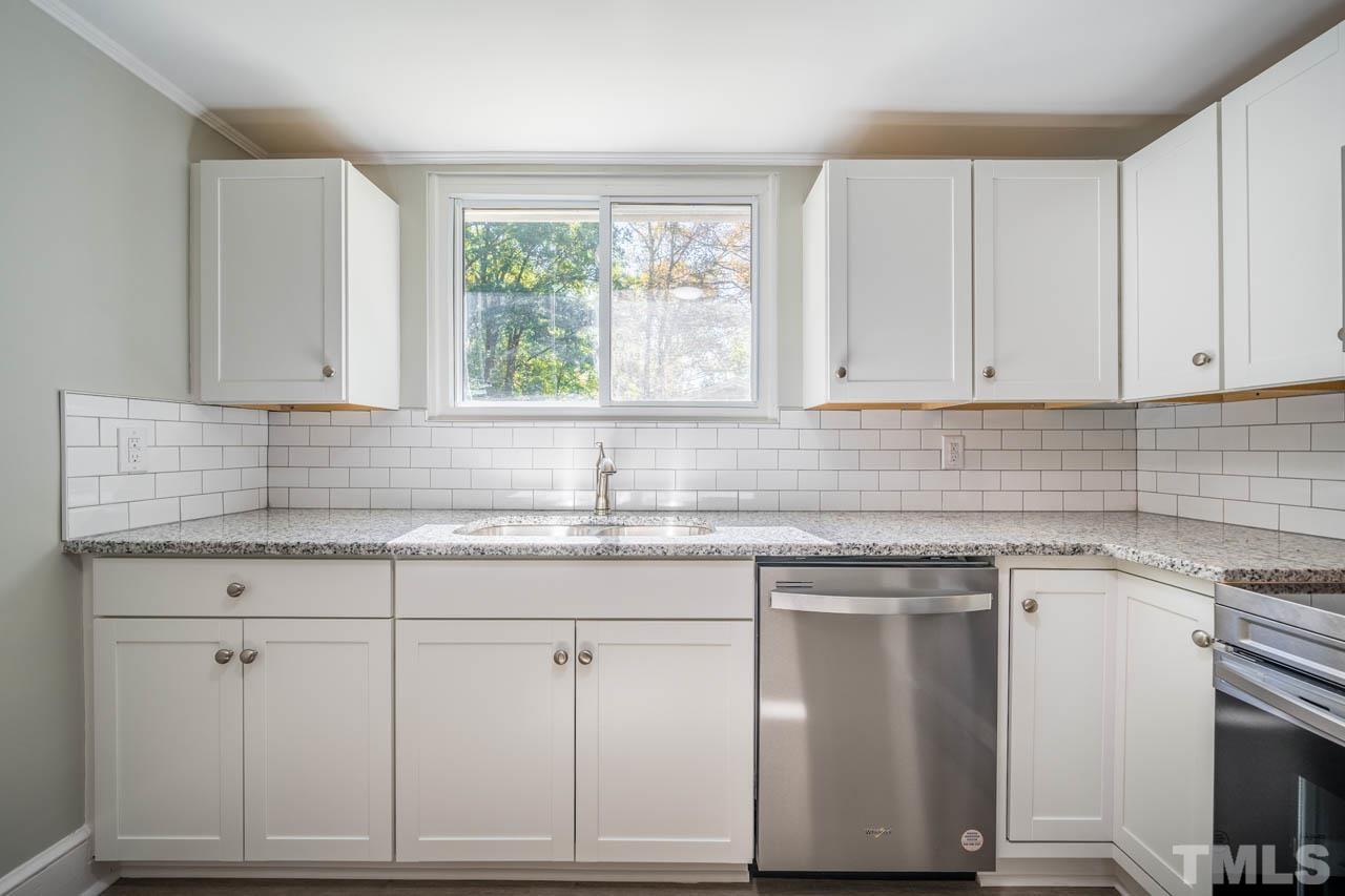 305 School House Road Efland, NC 27243 - Photo 29 of 35 a kitchen with granite countertop white cabinets and a sink