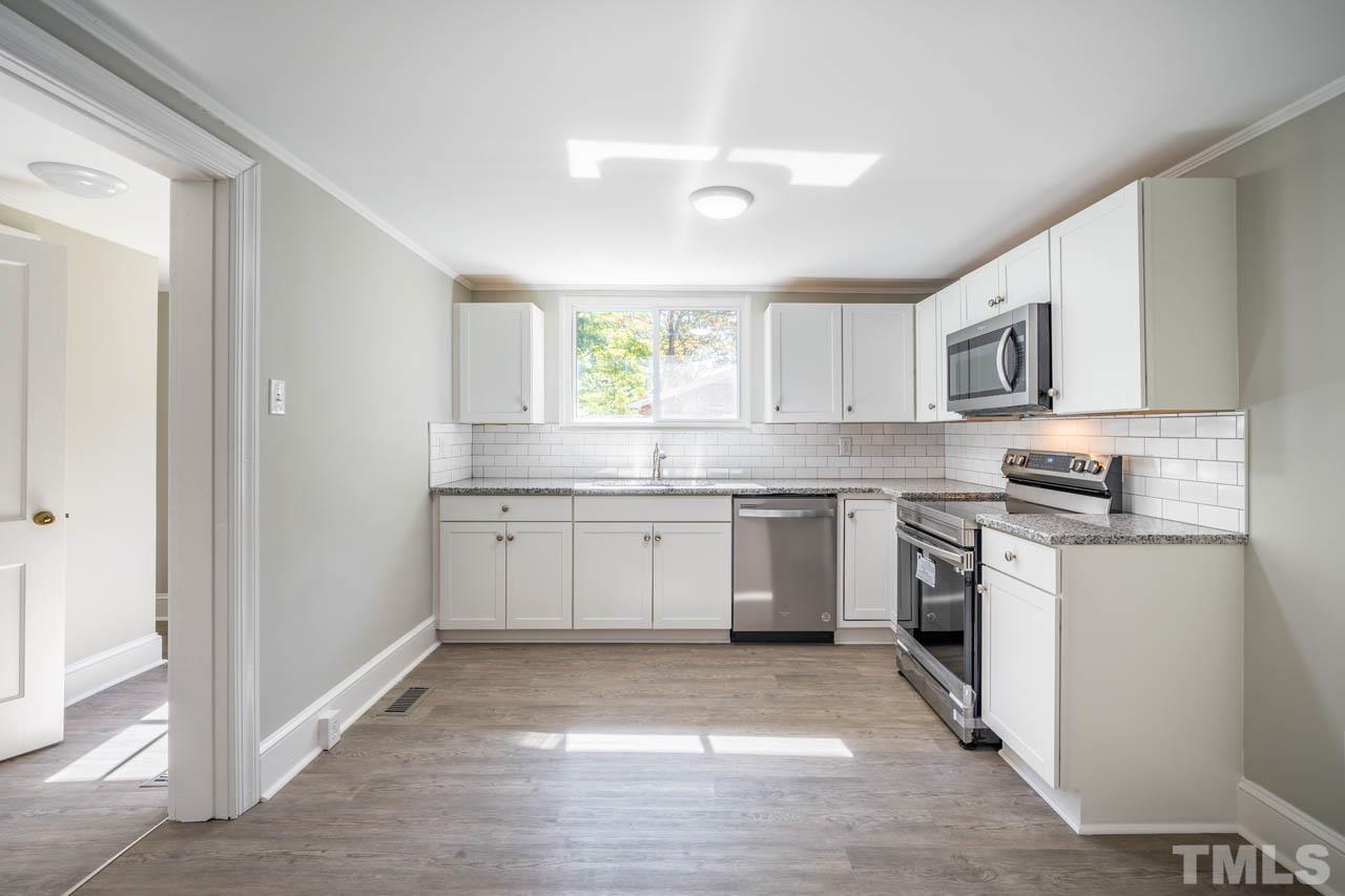 305 School House Road Efland, NC 27243 - Photo 35 of 35 a kitchen with a sink cabinets stainless steel appliances and a window