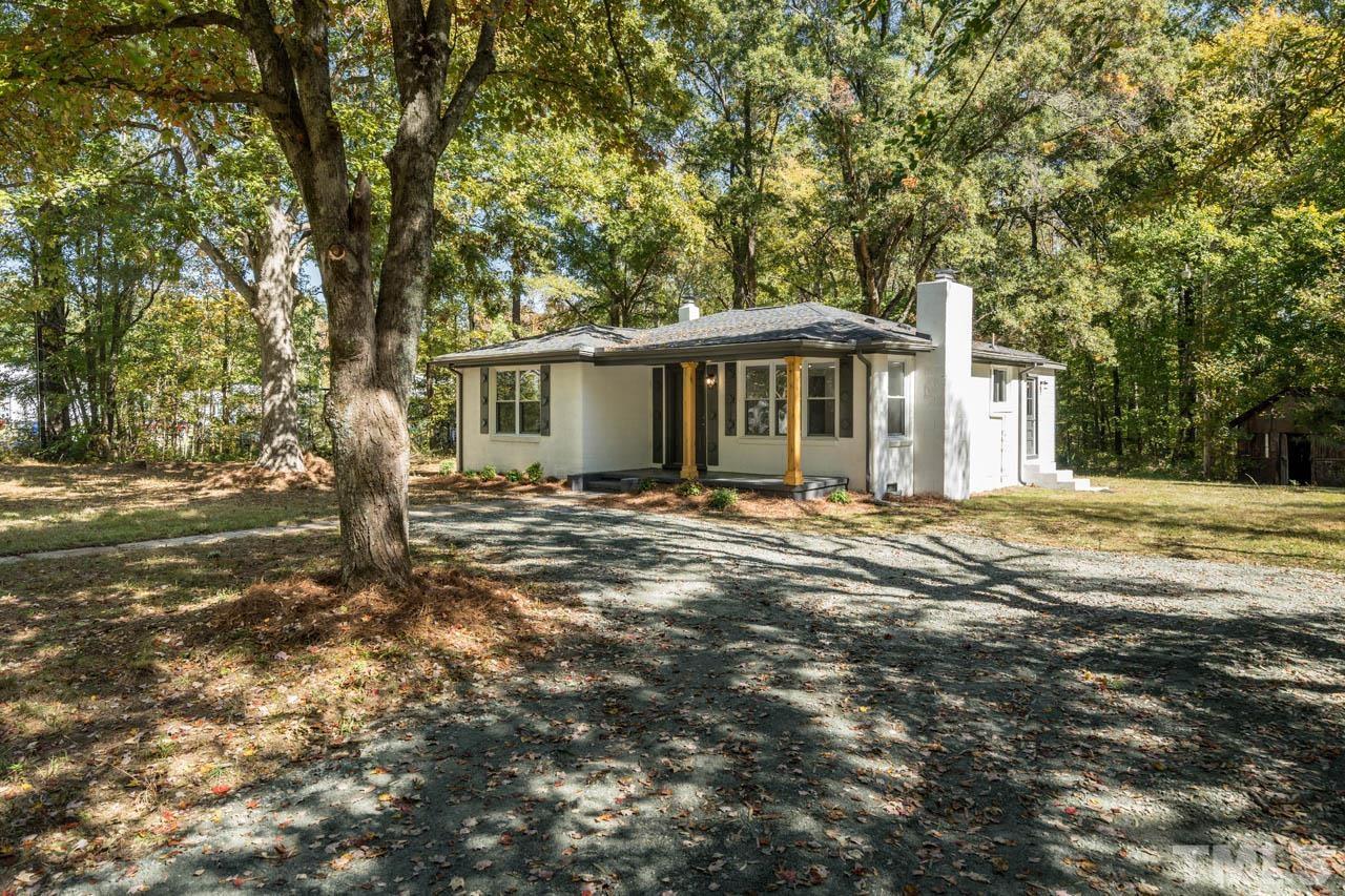 305 School House Road Efland, NC 27243 - Photo 4 of 35 a front view of a house with a garden