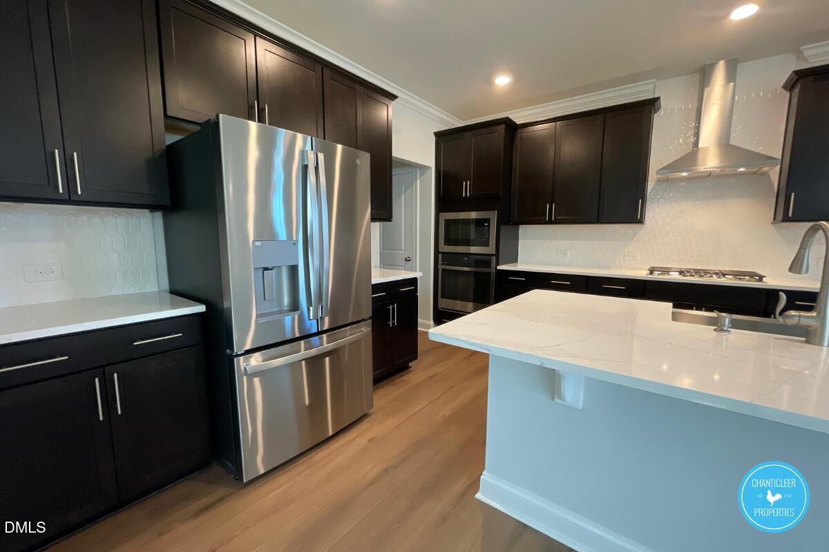 105 Chesapeake Way Chapel Hill, NC 27516 - Photo 3 of 26 a kitchen with stainless steel appliances a refrigerator and a microwave
