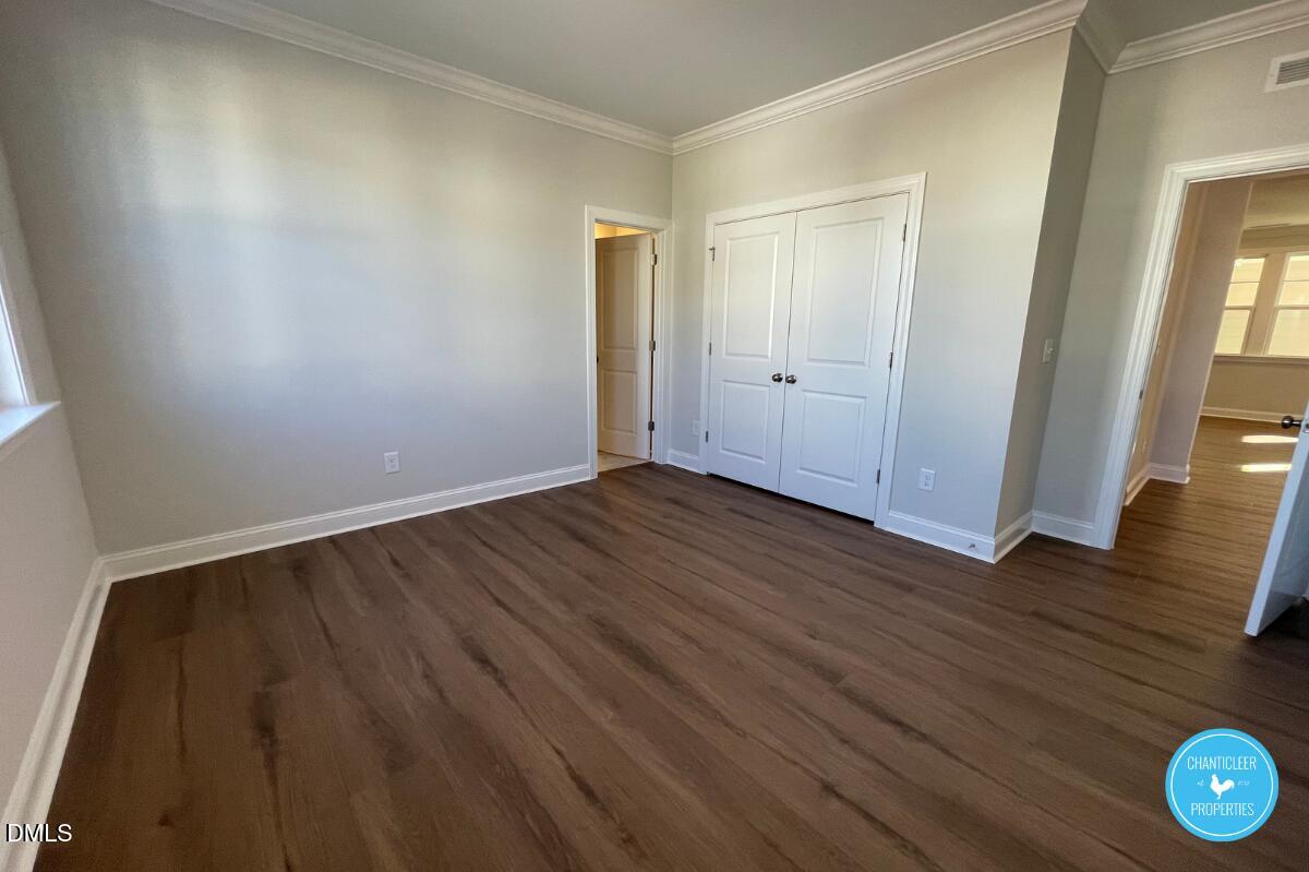 105 Chesapeake Way Chapel Hill, NC 27516 - Photo 8 of 26 an empty room with wooden floor and windows