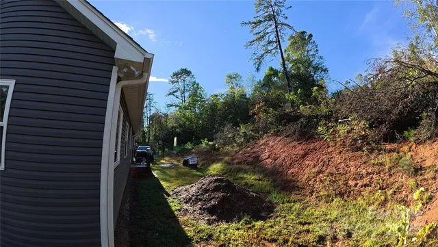 a view of a backyard with plants and flowers