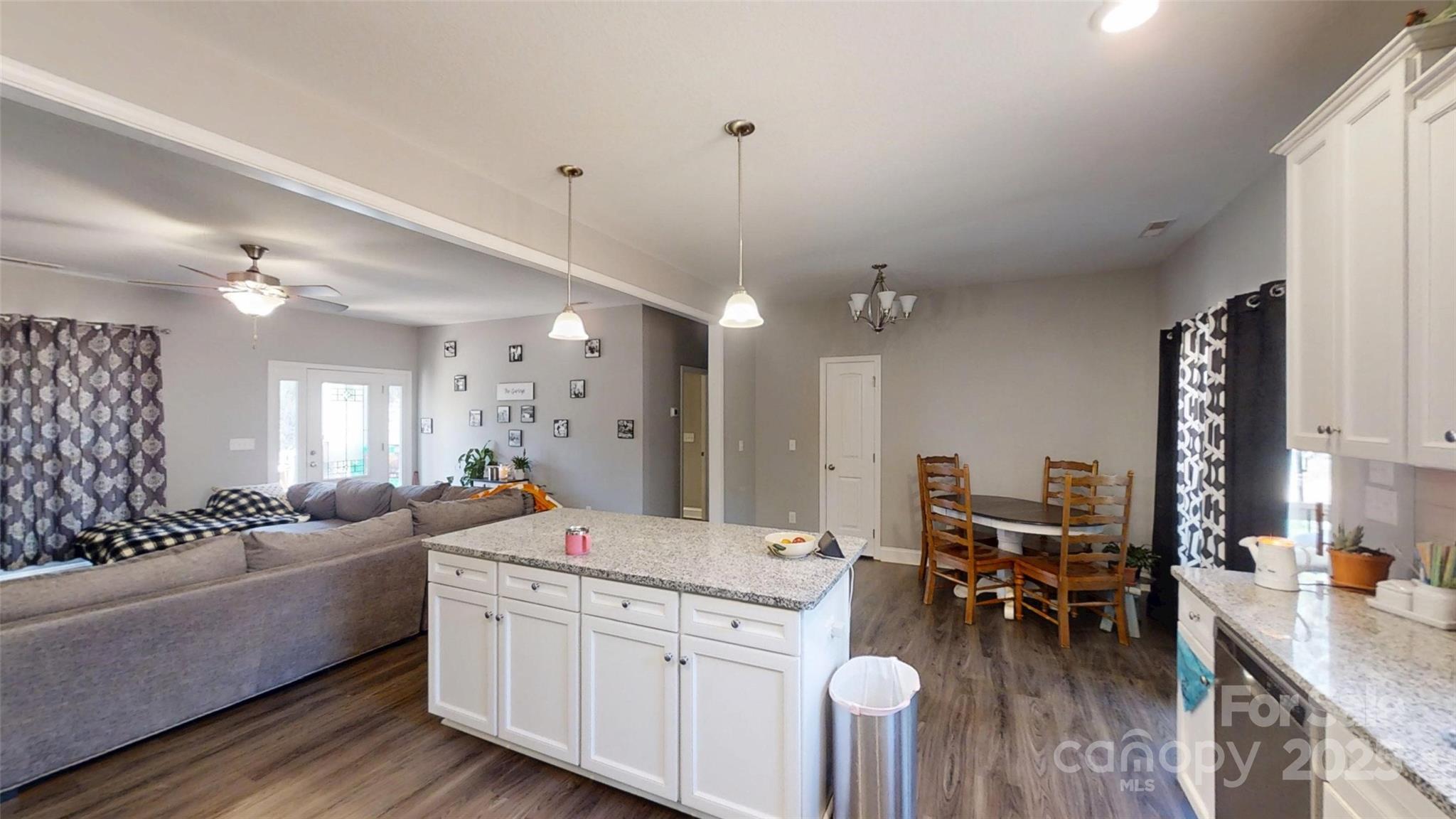 19 Higgins Road Weaverville, NC 28787 - Photo 27 of 48 a large living room with stainless steel appliances kitchen island granite countertop a couch and a view of living room