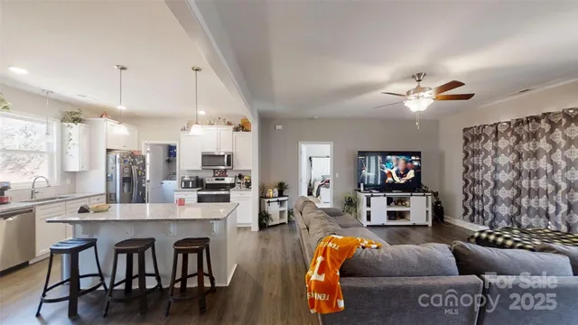 a kitchen with stainless steel appliances granite countertop a refrigerator stove and sink