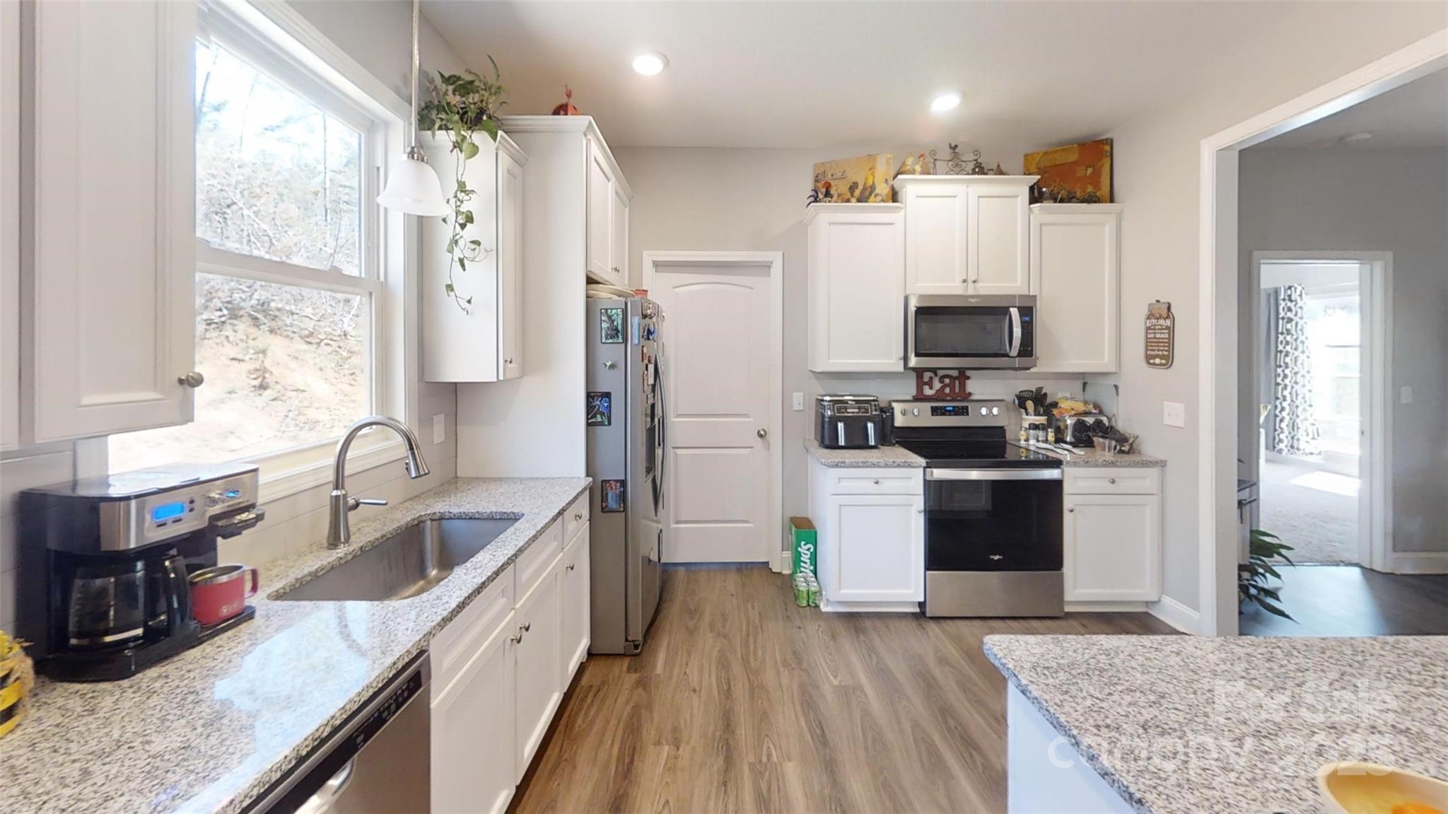 19 Higgins Road Weaverville, NC 28787 - Photo 29 of 48 a kitchen with stainless steel appliances granite countertop a refrigerator stove and sink