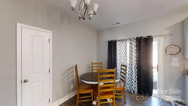 a kitchen with a refrigerator a stove a sink dishwasher a oven with white cabinets and wooden floor