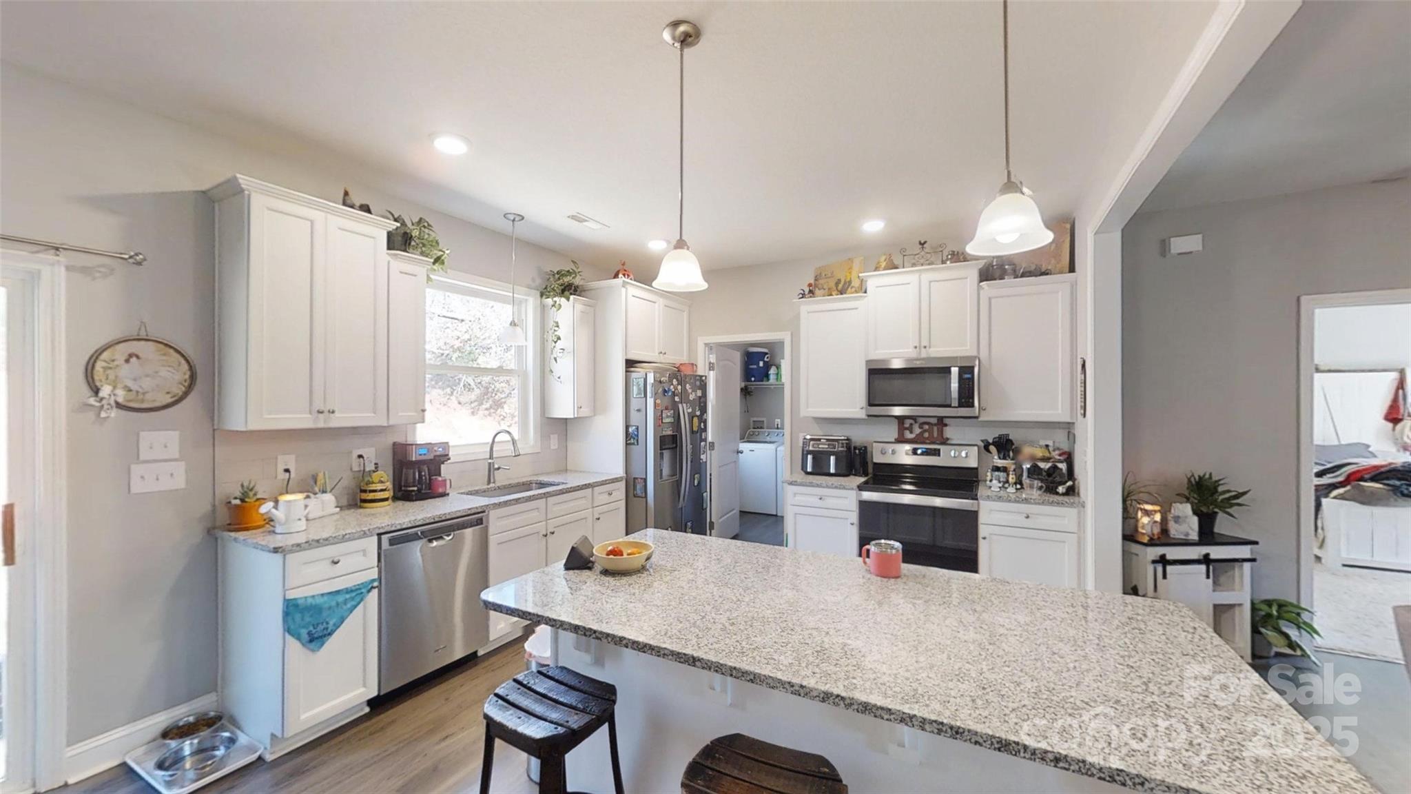19 Higgins Road Weaverville, NC 28787 - Photo 37 of 48 a kitchen with a refrigerator a stove a sink dishwasher a oven with white cabinets and wooden floor