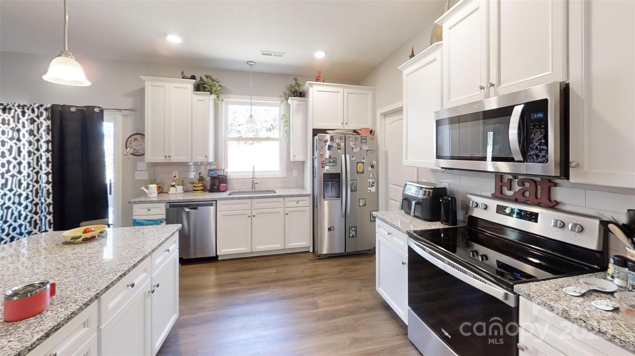 19 Higgins Road Weaverville, NC 28787 - Photo 38 of 48 a kitchen with stainless steel appliances kitchen island granite countertop a stove sink and refrigerator