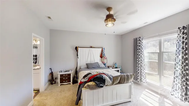 a view of a bedroom with workspace and natural light