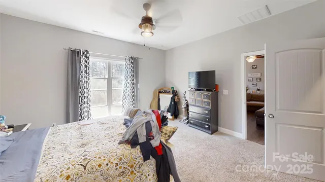 a bedroom that has a bed and a chandelier