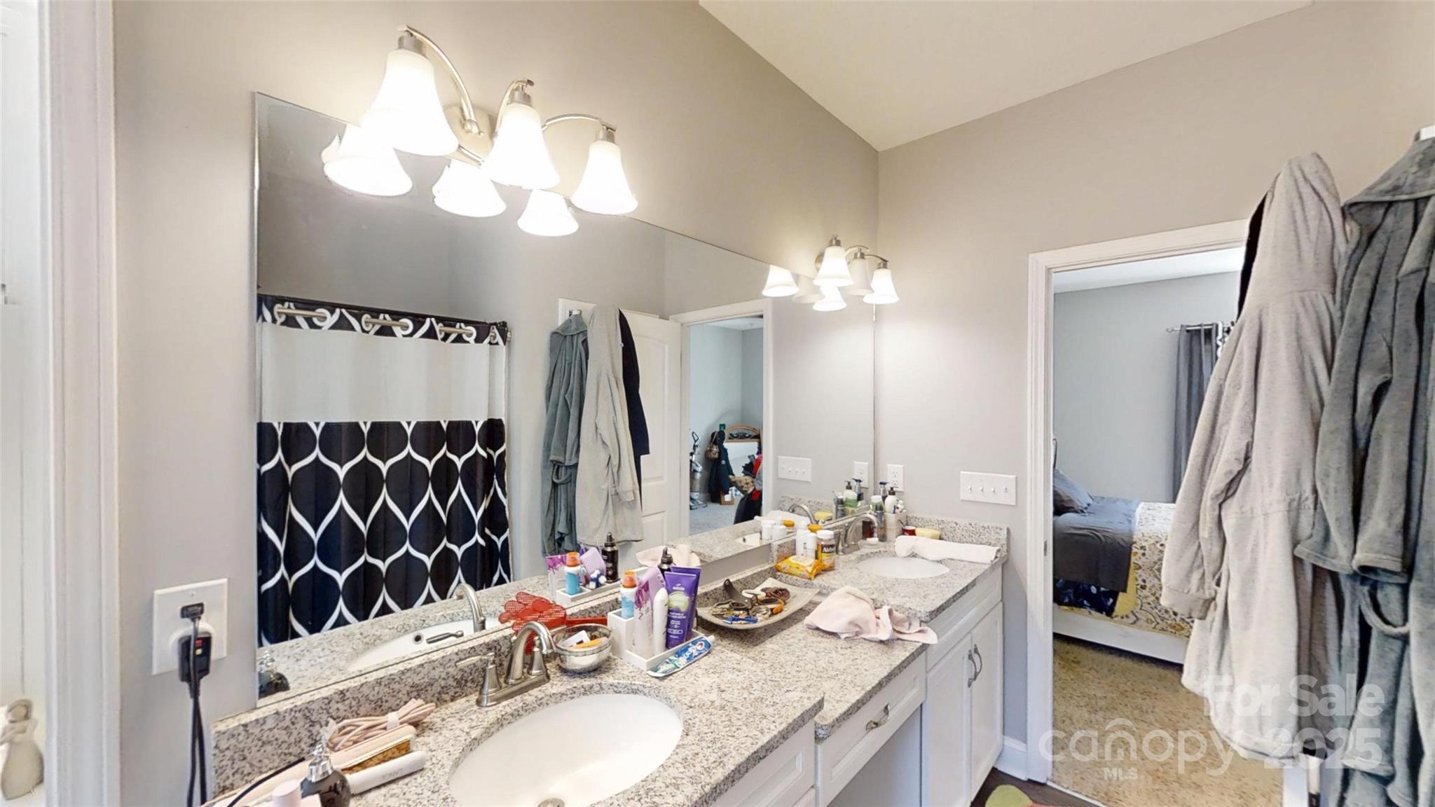 19 Higgins Road Weaverville, NC 28787 - Photo 44 of 48 a bathroom with a granite countertop sink and a mirror