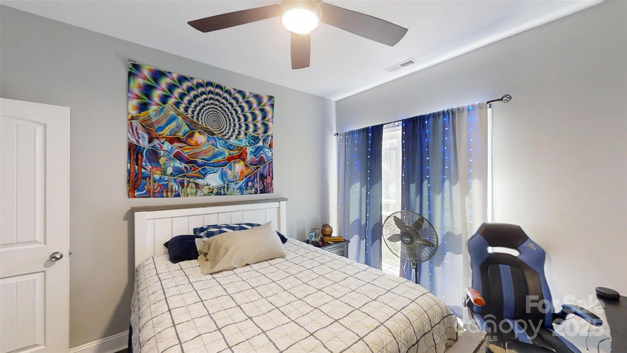 19 Higgins Road Weaverville, NC 28787 - Photo 45 of 48 a bedroom with a bed and a painting on the wall