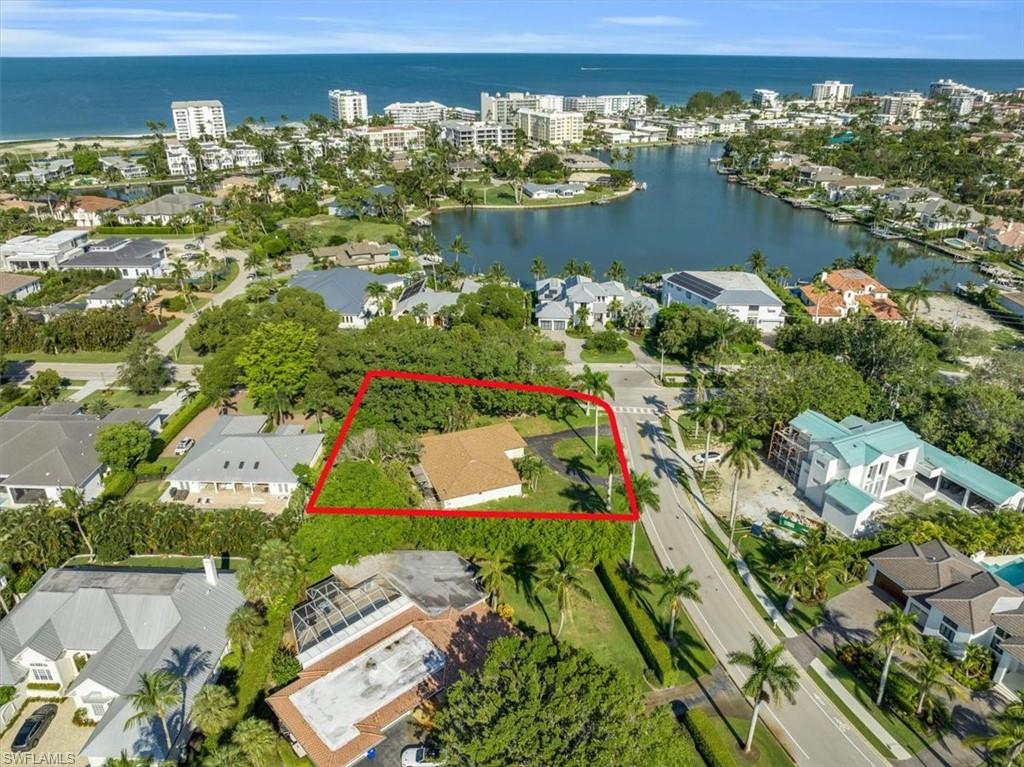 444 Orchid Drive Naples, FL 34102 - Photo 1 of 8 an aerial view of a house with a lake view