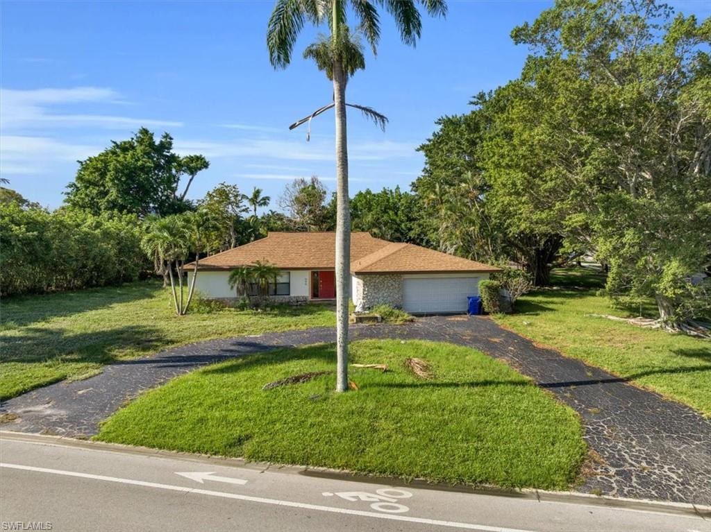 444 Orchid Drive Naples, FL 34102 - Photo 6 of 8 a view of a house with a yard
