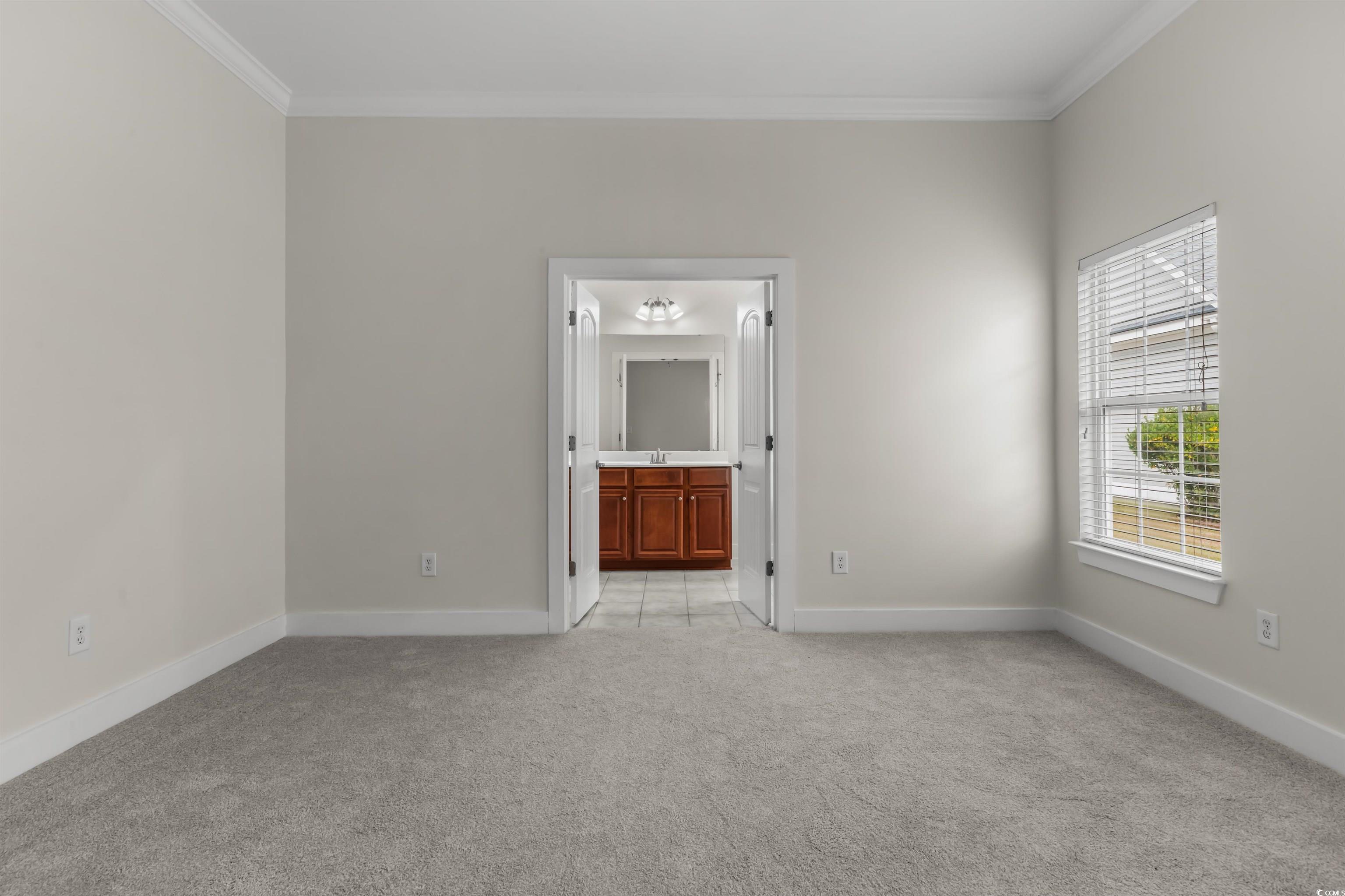 2006 Heritage Loop Myrtle Beach, SC 29577 - Photo 14 of 33 Empty room featuring ornamental molding and light carpet