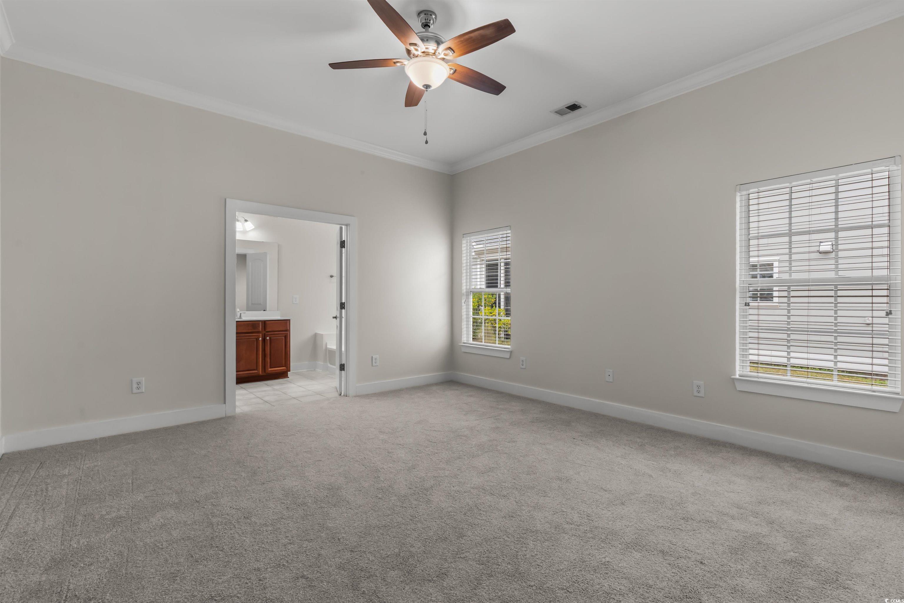 2006 Heritage Loop Myrtle Beach, SC 29577 - Photo 15 of 33 Spare room with crown molding, light carpet, and ceiling fan