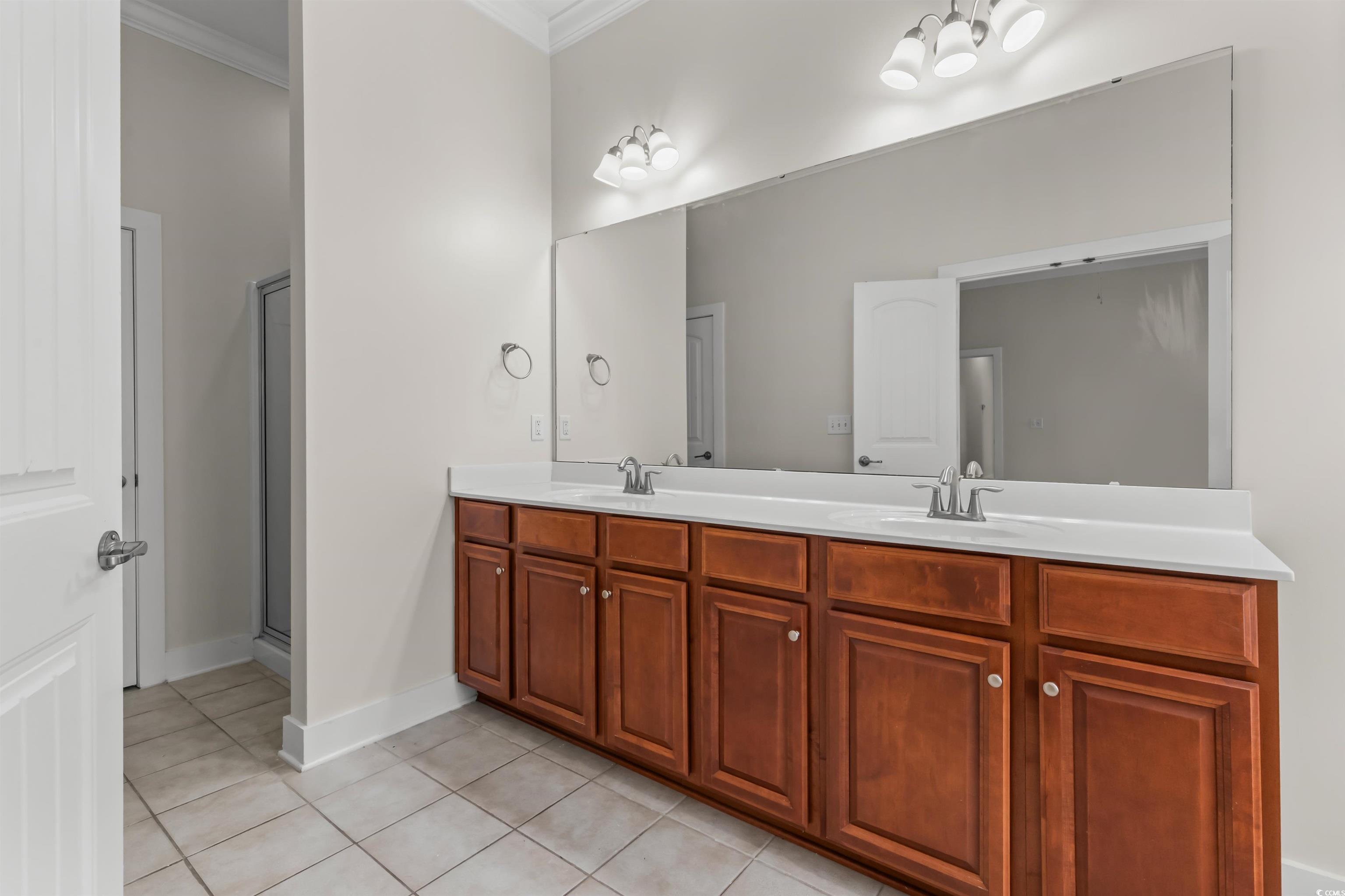 2006 Heritage Loop Myrtle Beach, SC 29577 - Photo 16 of 33 Full bathroom with double vanity, light tile patterned floors, a stall shower, and ornamental molding