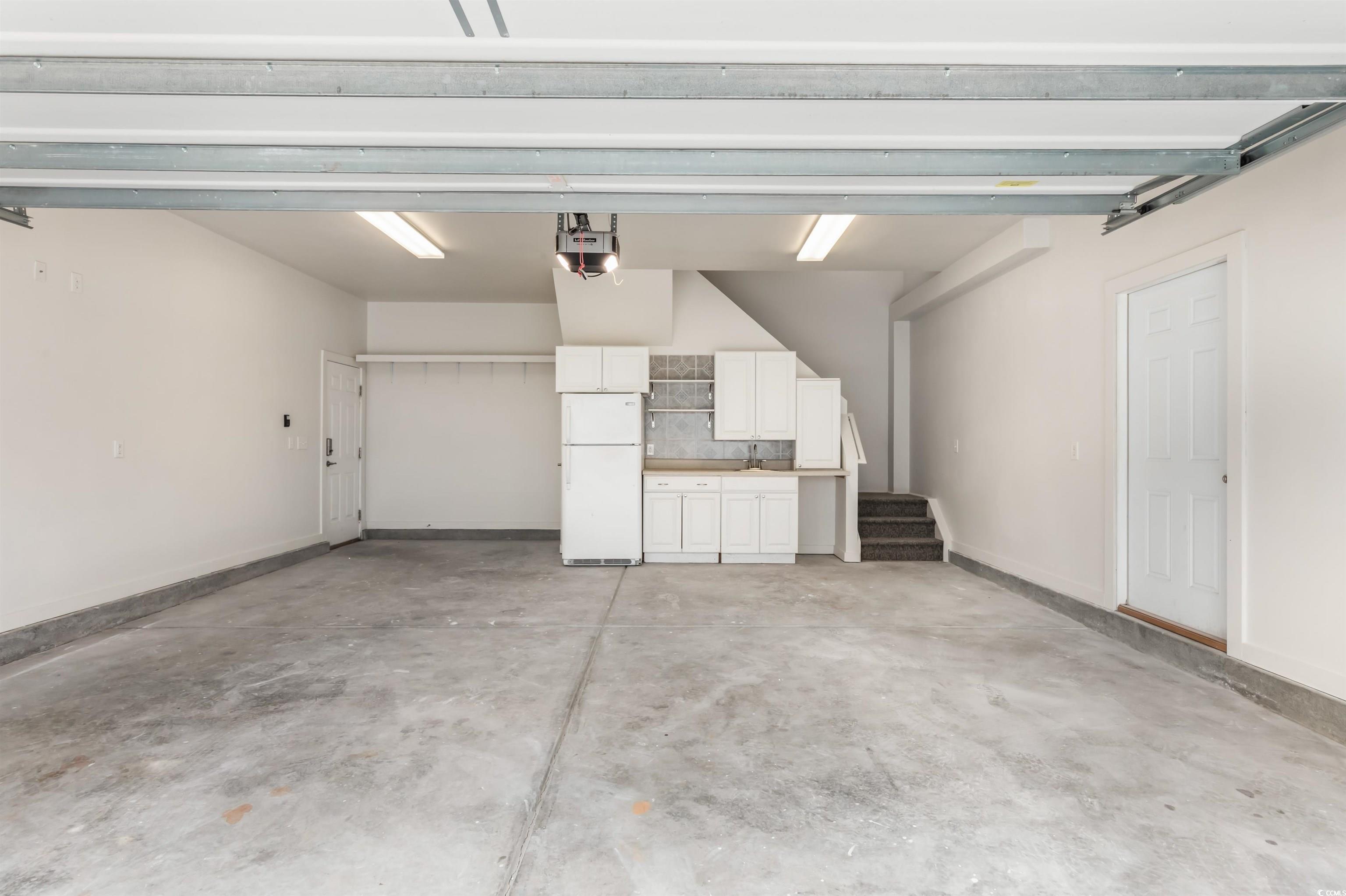2006 Heritage Loop Myrtle Beach, SC 29577 - Photo 22 of 33 Garage with freestanding refrigerator and a garage door opener