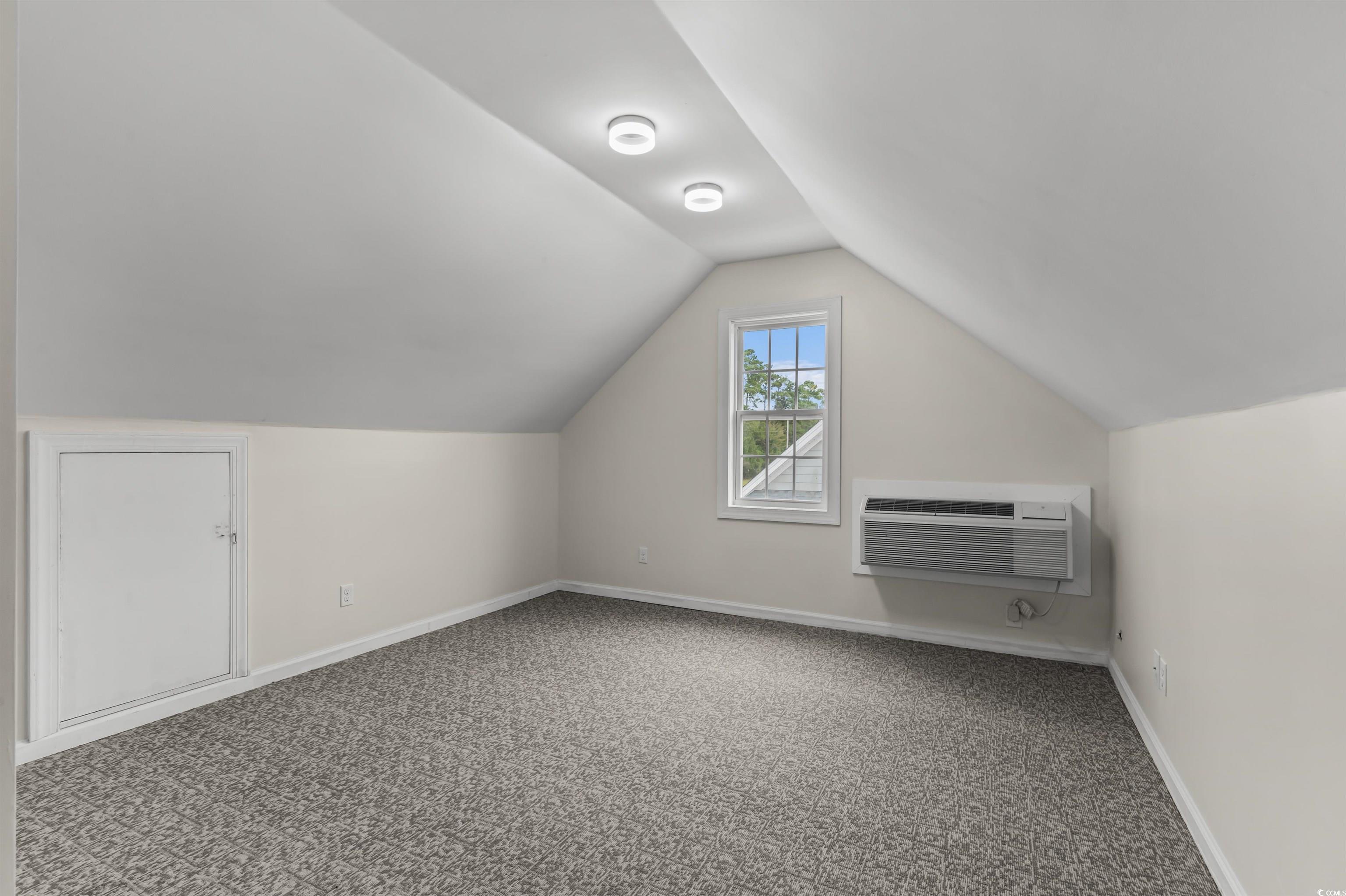2006 Heritage Loop Myrtle Beach, SC 29577 - Photo 25 of 33 Bonus room with carpet flooring, vaulted ceiling, and a wall mounted air conditioner