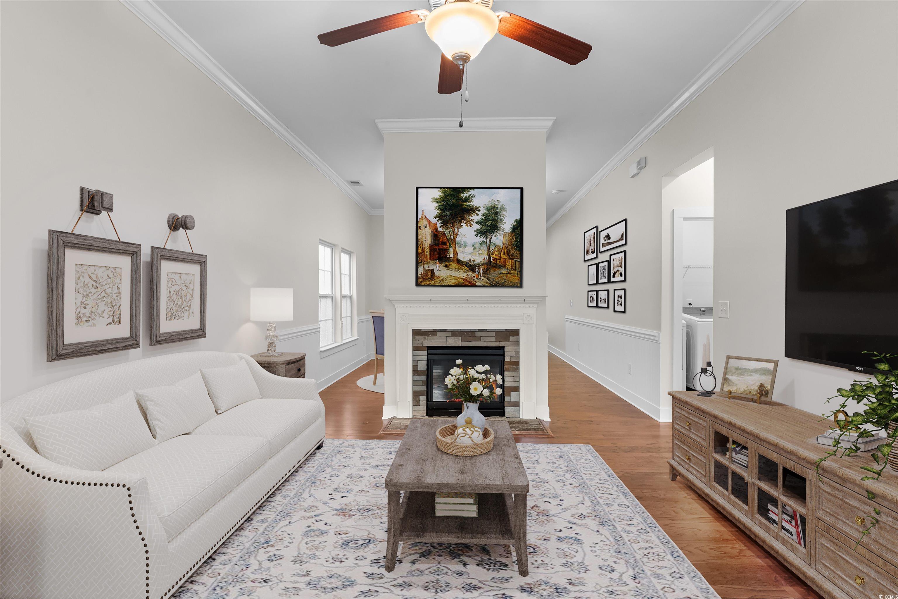 2006 Heritage Loop Myrtle Beach, SC 29577 - Photo 6 of 33 Living room featuring crown molding, wood finished floors, a ceiling fan, and a fireplace with flush hearth
