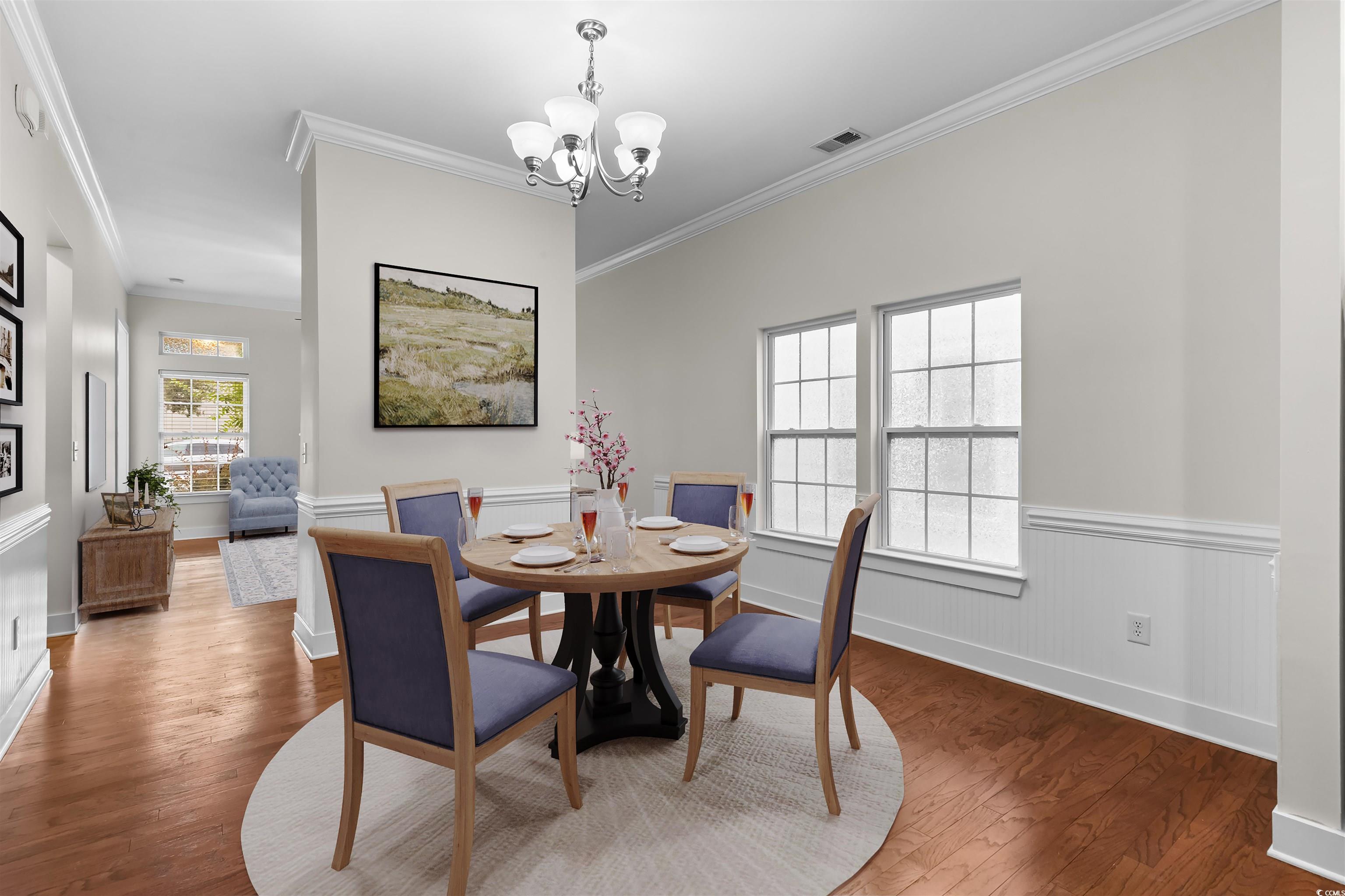 2006 Heritage Loop Myrtle Beach, SC 29577 - Photo 8 of 33 Dining area featuring crown molding, wood finished floors, and a chandelier