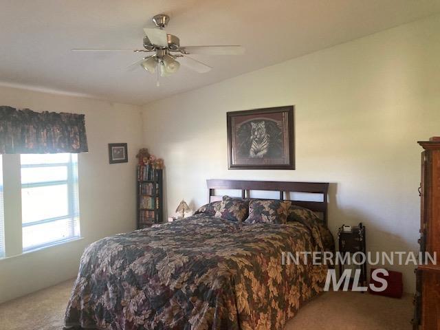 1095 County Road 70 Weiser, ID 83672 - Photo 16 of 44 Bedroom with vaulted ceiling, ceiling fan, and carpeted flooring