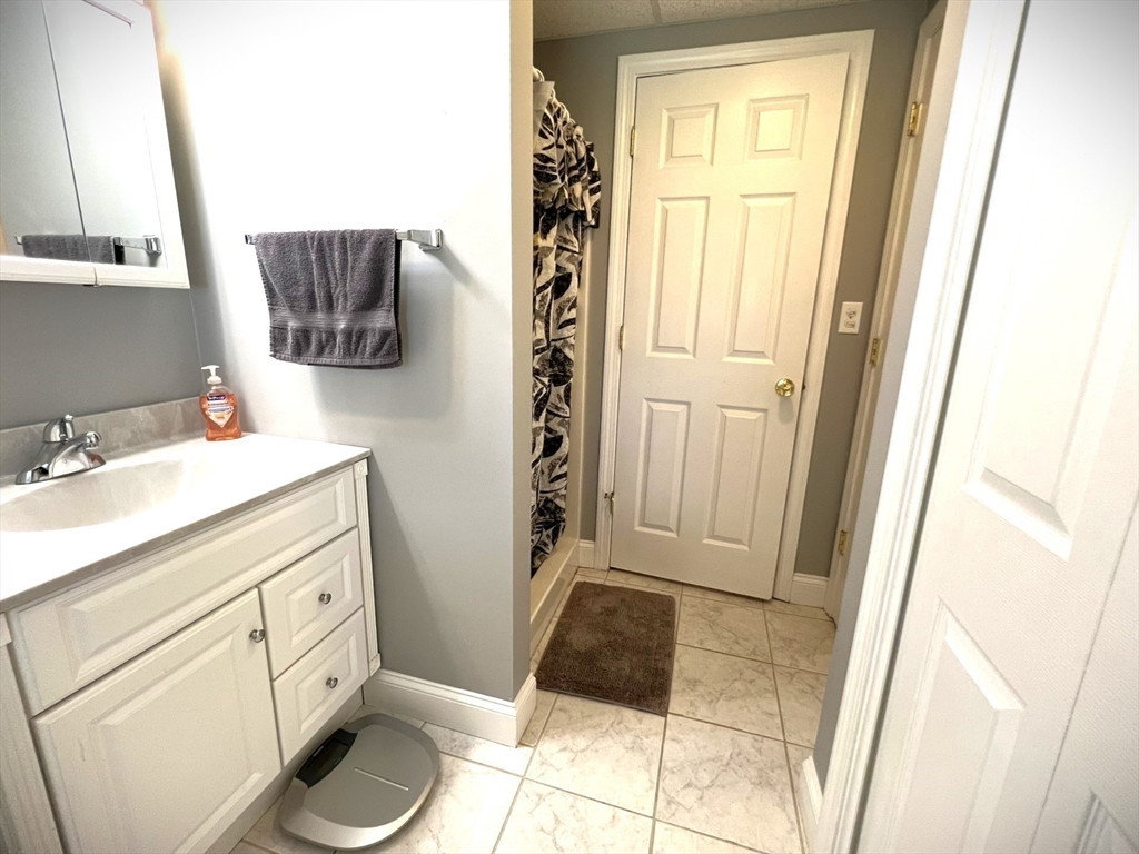 22 Hall Road Webster, MA 01570 - Photo 36 of 42 a bathroom with a sink a toilet a mirror and vanity