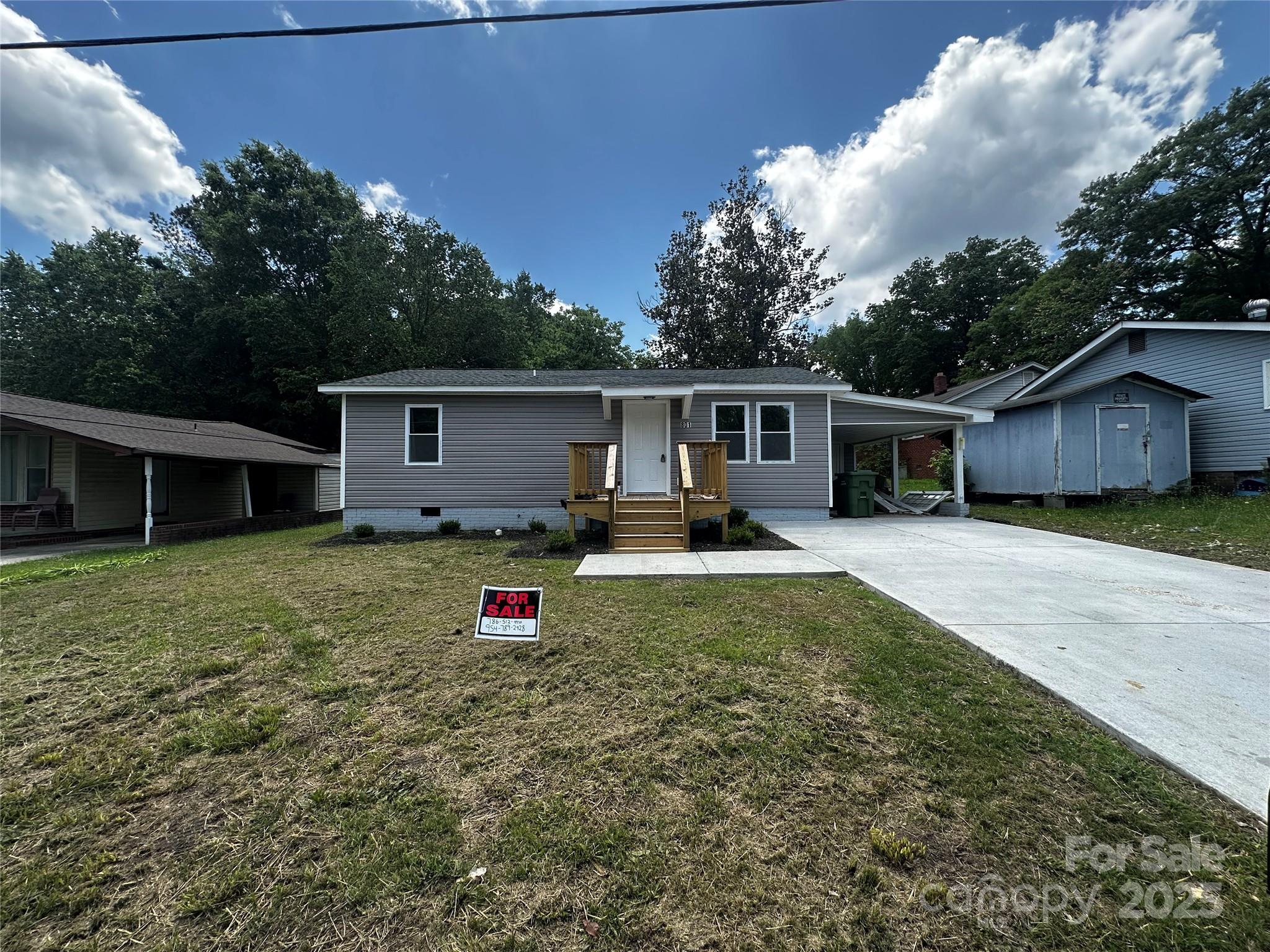 a view of a house with a backyard and a patio