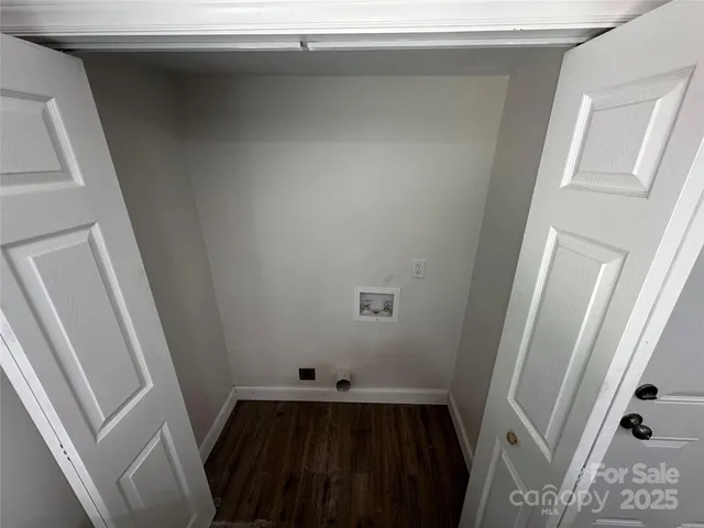 a view of a closet with wooden floor