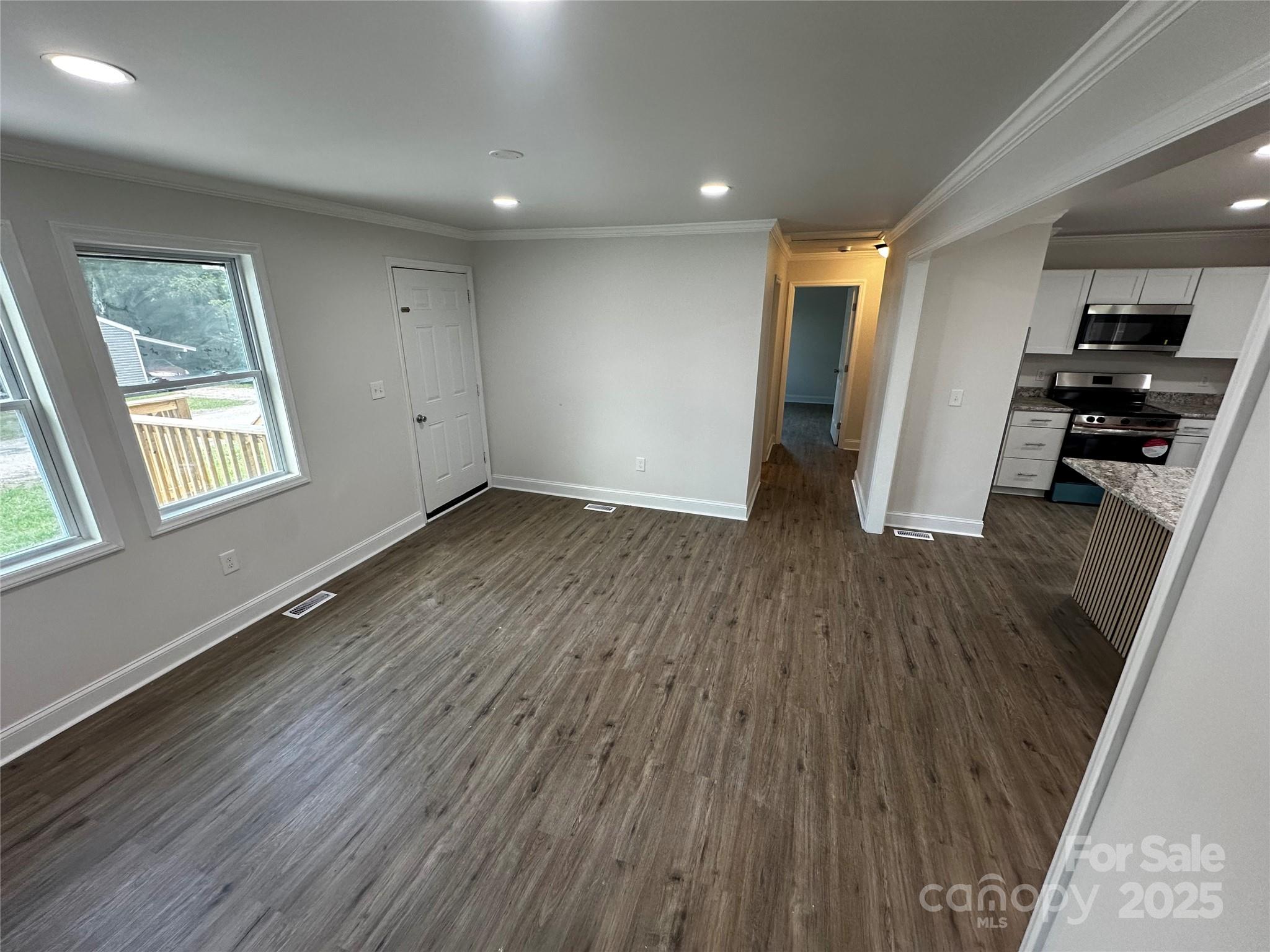 801 Calhoun Street Lancaster, SC 29720 - Photo 4 of 12 wooden floor in an empty room with a window