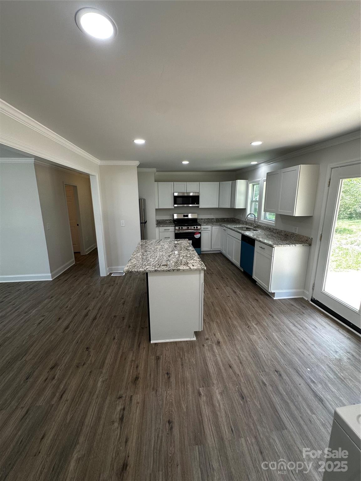 801 Calhoun Street Lancaster, SC 29720 - Photo 5 of 12 a kitchen with a sink dishwasher stove and wooden floor