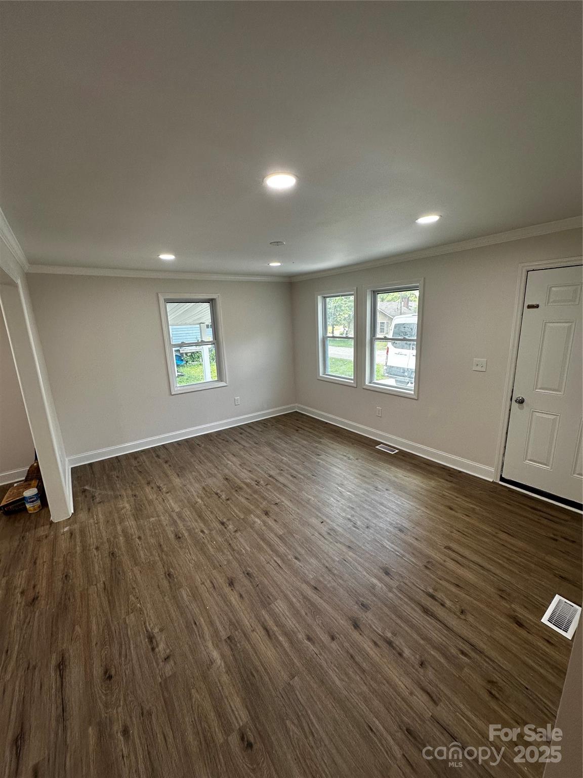 801 Calhoun Street Lancaster, SC 29720 - Photo 7 of 12 an empty room with wooden floor and windows