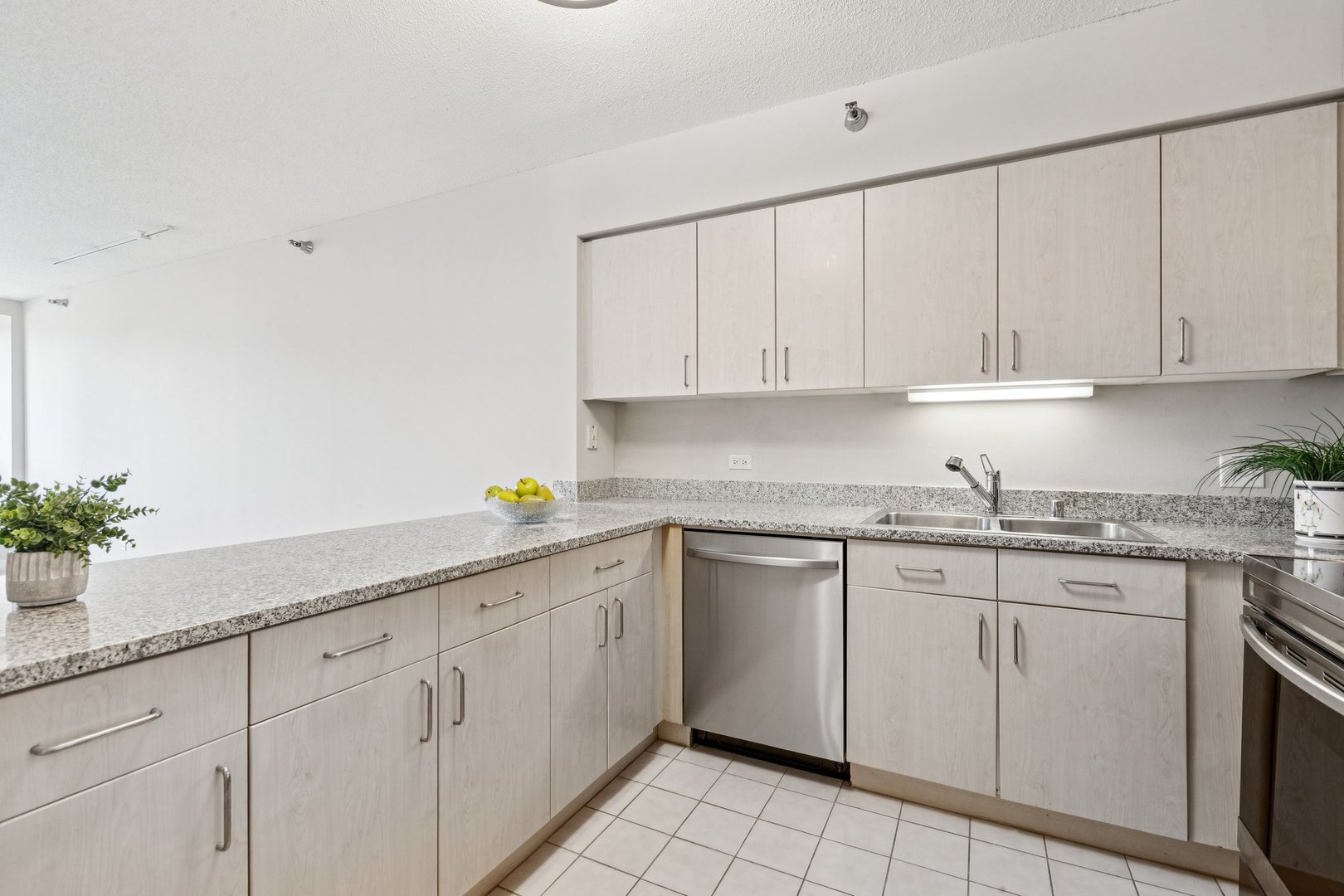 512 North McClurg Court, Unit 3312 Chicago, IL 60611 - Photo 11 of 47 a kitchen with granite countertop white cabinets white appliances and a sink