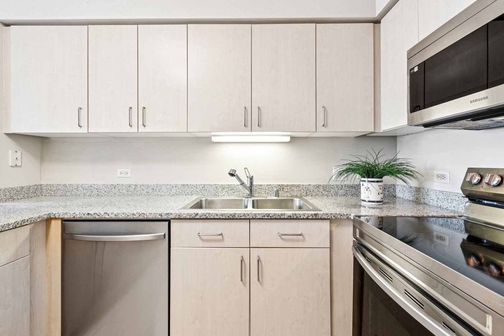 512 North McClurg Court, Unit 3312 Chicago, IL 60611 - Photo 12 of 47 a kitchen with granite countertop white cabinets and white appliances