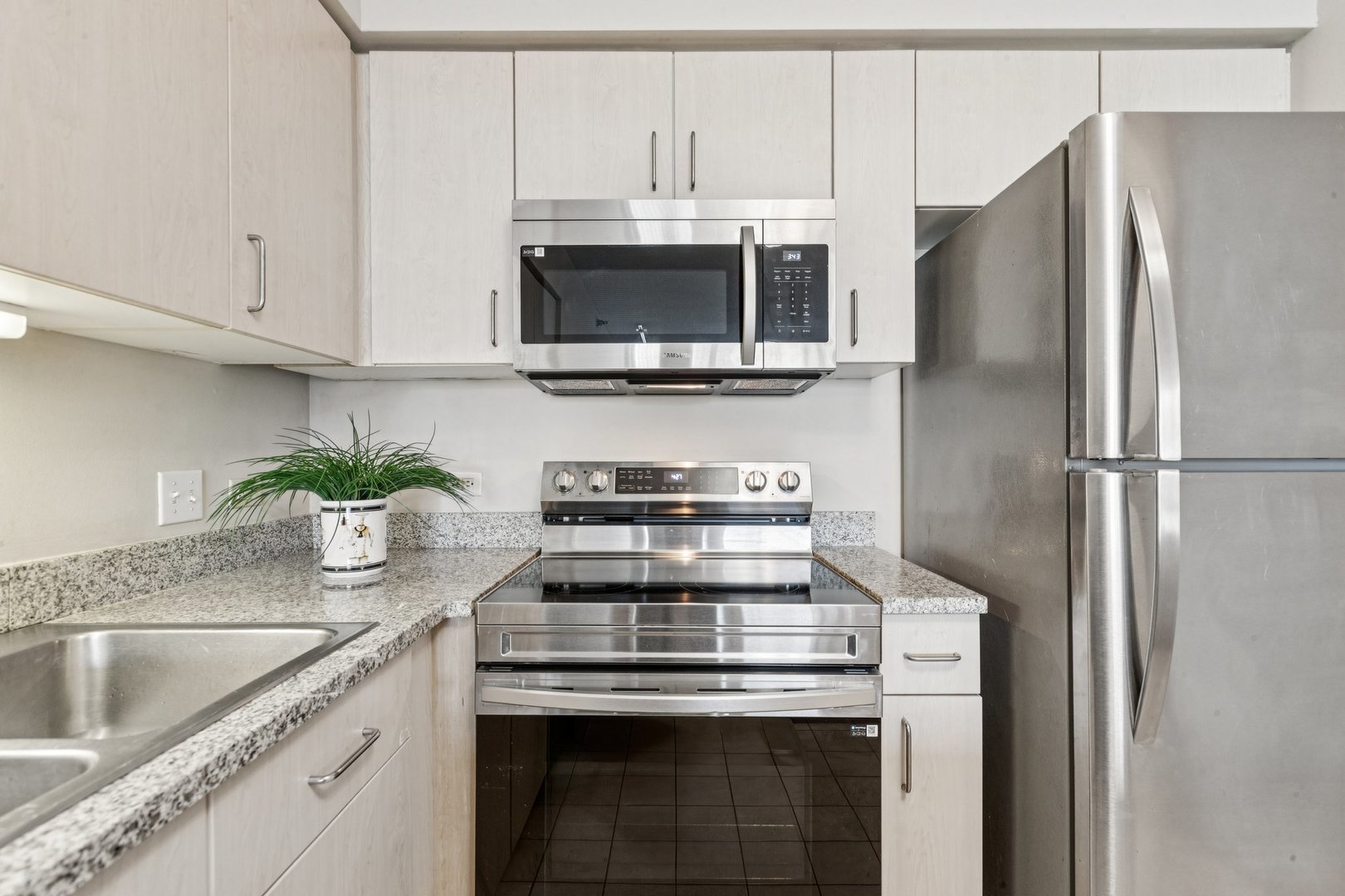 512 North McClurg Court, Unit 3312 Chicago, IL 60611 - Photo 13 of 47 a kitchen with stainless steel appliances granite countertop a stove and a refrigerator