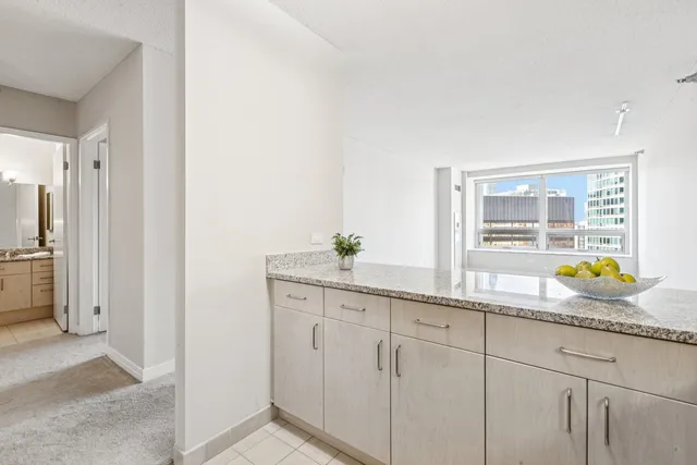 a bathroom with a granite countertop sink
