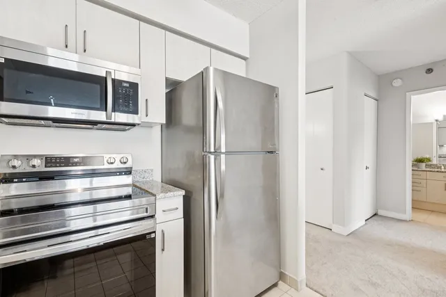 a kitchen with stainless steel appliances a refrigerator and a microwave