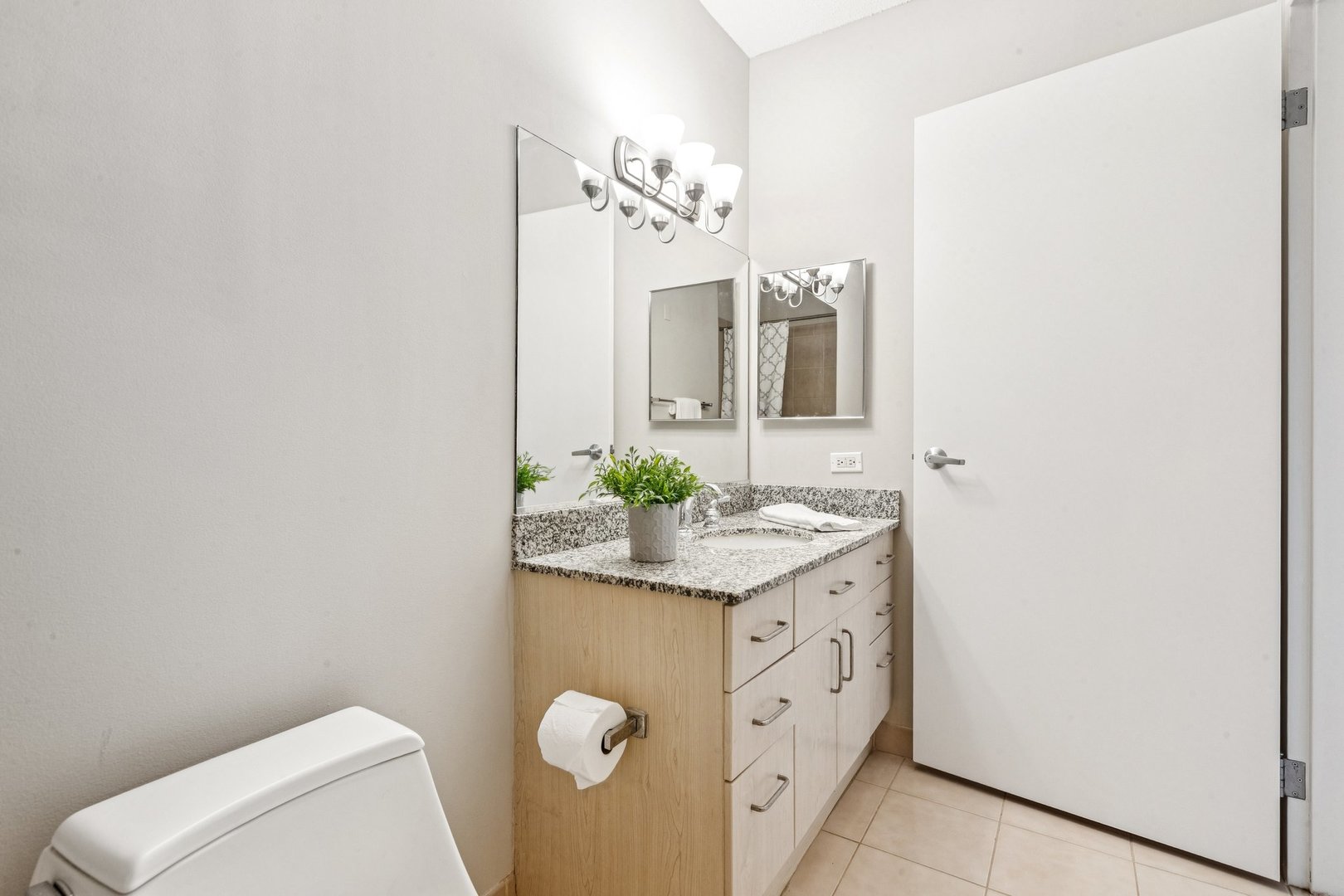 512 North McClurg Court, Unit 3312 Chicago, IL 60611 - Photo 20 of 47 a bathroom with a granite countertop sink and a mirror