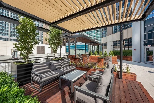 a view of a patio with table and chairs potted plants
