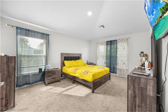 a bedroom with a bed and a night stand