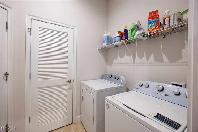 a kitchen with granite countertop a sink stainless steel appliances and white cabinets