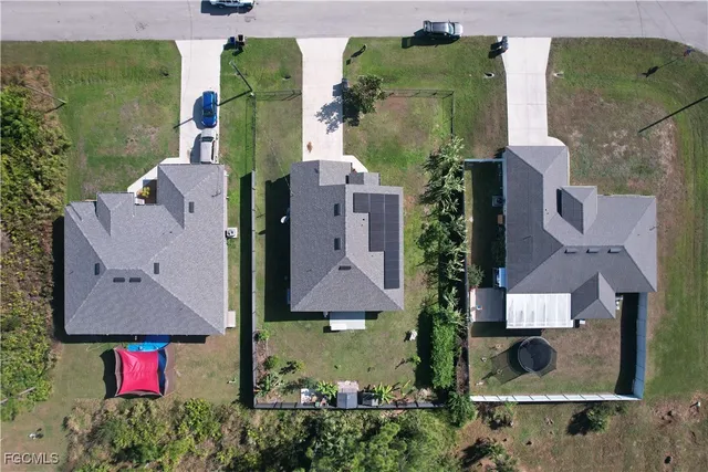 an aerial view of residential houses with outdoor space and street view