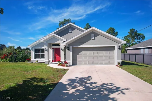 a front view of a house with a yard and garage