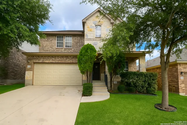 a front view of a house with a yard and garage