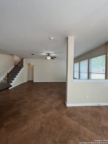 en empty room with windows and stairs